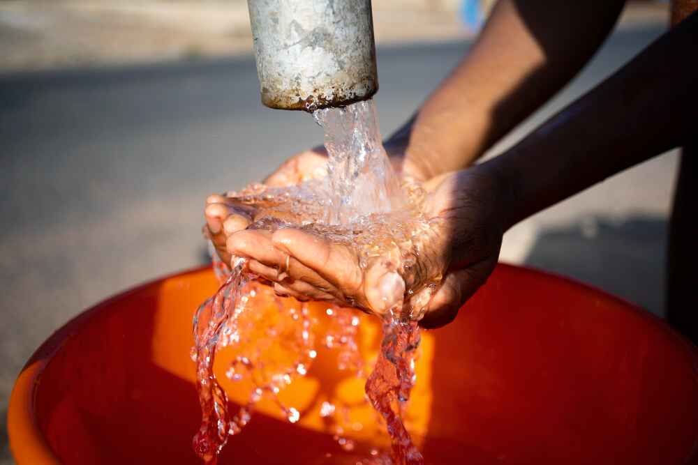 person holding water using hands